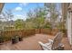 Relaxing back deck features wood railing, a white Adirondack chair, and wooded views at 1110 Links Rd., Myrtle Beach, SC 29575