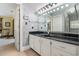 A powder room boasts a black counter with a white cabinet and a large mirror above the sink at 1110 Links Rd., Myrtle Beach, SC 29575