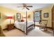 Traditional bedroom features a four-poster bed, ceiling fan, and window overlooking backyard at 1110 Links Rd., Myrtle Beach, SC 29575