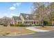 A traditional home displays a charming facade with a circular driveway and manicured landscaping at 1110 Links Rd., Myrtle Beach, SC 29575