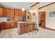 Kitchen with wooden cabinets, stainless steel appliances, an island with seating, and tile flooring at 1110 Links Rd., Myrtle Beach, SC 29575