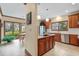 Well-lit kitchen featuring wooden cabinets, stainless steel appliances, island seating, and breakfast nook at 1110 Links Rd., Myrtle Beach, SC 29575