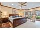 This main bedroom features dark wood accents, large windows, ceiling fan and sitting area at 1110 Links Rd., Myrtle Beach, SC 29575