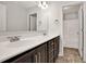 Bathroom featuring double sink vanity with dark wood cabinets, a large mirror, and an open doorway to the bath and toilet at 1111 Forest Bend Dr., Calabash, NC 28467