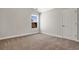 Bright bedroom features neutral carpet, a window for natural light, and a door for easy access at 1111 Forest Bend Dr., Calabash, NC 28467