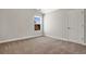 Bedroom with neutral walls, carpet floors, and a view of the roof of the neighboring house at 1111 Forest Bend Dr., Calabash, NC 28467
