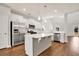 Modern kitchen with stainless steel appliances, island with quartz countertop and pendant lighting at 1111 Forest Bend Dr., Calabash, NC 28467