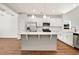 Well-lit kitchen features white cabinets, stainless steel appliances, and a kitchen island at 1111 Forest Bend Dr., Calabash, NC 28467