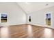 Bright living room featuring wood flooring, high ceilings, and natural light from two windows at 1111 Forest Bend Dr., Calabash, NC 28467