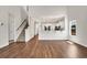 Spacious living area with hardwood floors, a staircase, and an open view into a modern kitchen at 1111 Forest Bend Dr., Calabash, NC 28467