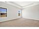 Spacious main bedroom with tray ceiling, carpeted floors, and natural light from two windows at 1111 Forest Bend Dr., Calabash, NC 28467