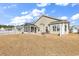 Wide view of backyard with patio, sunroom, and well-maintained lawn at 1166 Bethpage Dr., Myrtle Beach, SC 29579