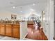 Open-concept kitchen with granite countertops and rich wood floors leading to the living room at 1166 Bethpage Dr., Myrtle Beach, SC 29579