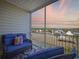 Relaxing screened balcony offers comfortable seating and serene water views at sunset at 117 Ella Kinley Circle # 302, Myrtle Beach, SC 29588