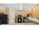 Functional kitchen featuring wooden cabinets and essential black appliances at 117 Ella Kinley Circle # 302, Myrtle Beach, SC 29588