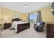 Serene main bedroom with a queen bed and comfortable seating near a bright window at 117 Ella Kinley Circle # 302, Myrtle Beach, SC 29588