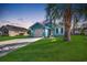 Charming blue single-story home featuring a well-maintained front yard with a classic white garage door at 1205 Formby Ct., Myrtle Beach, SC 29588