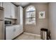 Bright kitchen featuring stainless steel appliances, white cabinets, and a large window above the sink at 1205 Formby Ct., Myrtle Beach, SC 29588