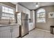 Bright kitchen featuring stainless steel appliances, white cabinets, and a large window above the sink at 1205 Formby Ct., Myrtle Beach, SC 29588