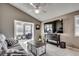 Comfortable living room with large television, neutral tile floors and plentiful natural light at 1205 Formby Ct., Myrtle Beach, SC 29588