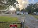 Property with a grassy yard, multiple outbuildings, and a driveway at 127 Nu-Shell St, Georgetown, SC 29440