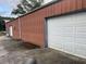 Exterior of a garage, with multiple bays, and a red metal exterior at 127 Nu-Shell St, Georgetown, SC 29440