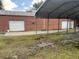 Exterior of a garage, with multiple bays, and a metal awning covering the front at 127 Nu-Shell St, Georgetown, SC 29440