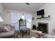 Cozy living room with vaulted ceiling, fireplace, and lots of natural light from sliding glass doors at 129 Hartland Dr. # 8-I, Myrtle Beach, SC 29572