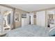 Bright bedroom featuring a blue patterned bedspread and a glass door leading to a balcony with natural light at 1310 N Waccamaw Dr. # 208, Garden City Beach, SC 29576