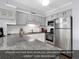 Modern kitchen with stainless steel appliances and granite countertops at 1310 N Waccamaw Dr. # 208, Garden City Beach, SC 29576