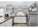 Galley kitchen featuring stainless steel appliances, white subway tile backsplash, and granite countertops at 1310 N Waccamaw Dr. # 208, Garden City Beach, SC 29576