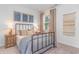 Cozy bedroom is decorated with nautical art, rustic furnishings, and a comfortable bed at 140 Leyland Cypress Dr, Conway, SC 29527