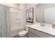 Bright bathroom with a shower-tub combo, grey vanity, framed mirror and a decorative sailboat wall art at 141 Leyland Cypress Dr, Conway, SC 29527