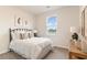 Charming bedroom with a black metal bed frame, white bedding and large window providing plenty of natural light at 141 Leyland Cypress Dr, Conway, SC 29527