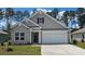 Charming single-Gathering home showcasing a two-car garage and neutral-toned siding at 141 Leyland Cypress Dr, Conway, SC 29527