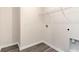 Minimalist laundry room featuring sleek wood-look floors, white walls, and electrical and plumbing hookups at 141 Leyland Cypress Dr, Conway, SC 29527