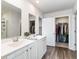 Bright bathroom with double sinks, large mirrors, white cabinets and a walk-in closet for ample storage at 1504 Oyster Bay Ct., Myrtle Beach, SC 29588