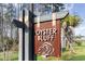 Community sign for Oyster Bluff with weathered wood and bronze accents, nestled among palm trees and foliage at 1504 Oyster Bay Ct., Myrtle Beach, SC 29588