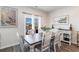 Bright dining room with a wooden table, white chairs, and an elegant decorative sideboard at 1504 Oyster Bay Ct., Myrtle Beach, SC 29588