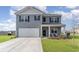 Well-maintained two-story home featuring gray siding, a front porch, and a two-car garage at 1504 Oyster Bay Ct., Myrtle Beach, SC 29588