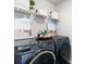 Modern laundry room featuring a gray washer and dryer, complemented by stylish decor and ample storage at 1504 Oyster Bay Ct., Myrtle Beach, SC 29588