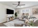 Comfortable living room featuring a large sectional sofa, ceiling fan, and serene decor at 1504 Oyster Bay Ct., Myrtle Beach, SC 29588