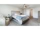 Serene main bedroom with a ceiling fan, a cozy armchair, and soft bedding for a relaxing retreat at 1504 Oyster Bay Ct., Myrtle Beach, SC 29588