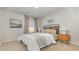 Cozy bedroom featuring warm earth tones, a stylish headboard, and bright natural light from the window at 153 Leyland Cypress Dr, Conway, SC 29527