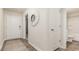 Inviting hallway with wood-look flooring, a decorative mirror, and access to the bathroom at 153 Leyland Cypress Dr, Conway, SC 29527