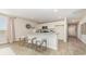 Bright kitchen with wood-look floors, kitchen island and adjacent living room at 153 Leyland Cypress Dr, Conway, SC 29527
