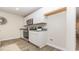 Well-lit kitchen with stainless steel appliances and white cabinets, next to washer and dryer hookups at 153 Leyland Cypress Dr, Conway, SC 29527