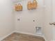 A clean and functional laundry room with overhead storage and utility connections at 153 Leyland Cypress Dr, Conway, SC 29527