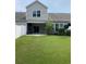 Backyard showcasing the green lawn and a partial view of the house with a white fence at 156 Parmelee Dr. # B, Murrells Inlet, SC 29576