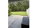 A fenced-in backyard with a concrete patio and a dark wooden bench, perfect for relaxation at 156 Parmelee Dr. # B, Murrells Inlet, SC 29576